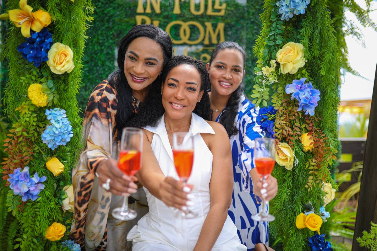 Cheers all around as (from left) Paula Nesbeth Wright, CEO of Viniflex Jamaica Ltd; attorney-at-law Roxann C. Mars; and Dr Jhenelle Hew, strike a pose for the camera.