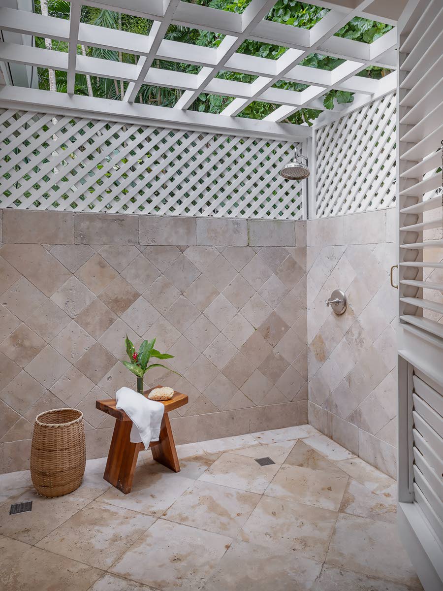 An outdoor rain shower hidden amongst the greenery.