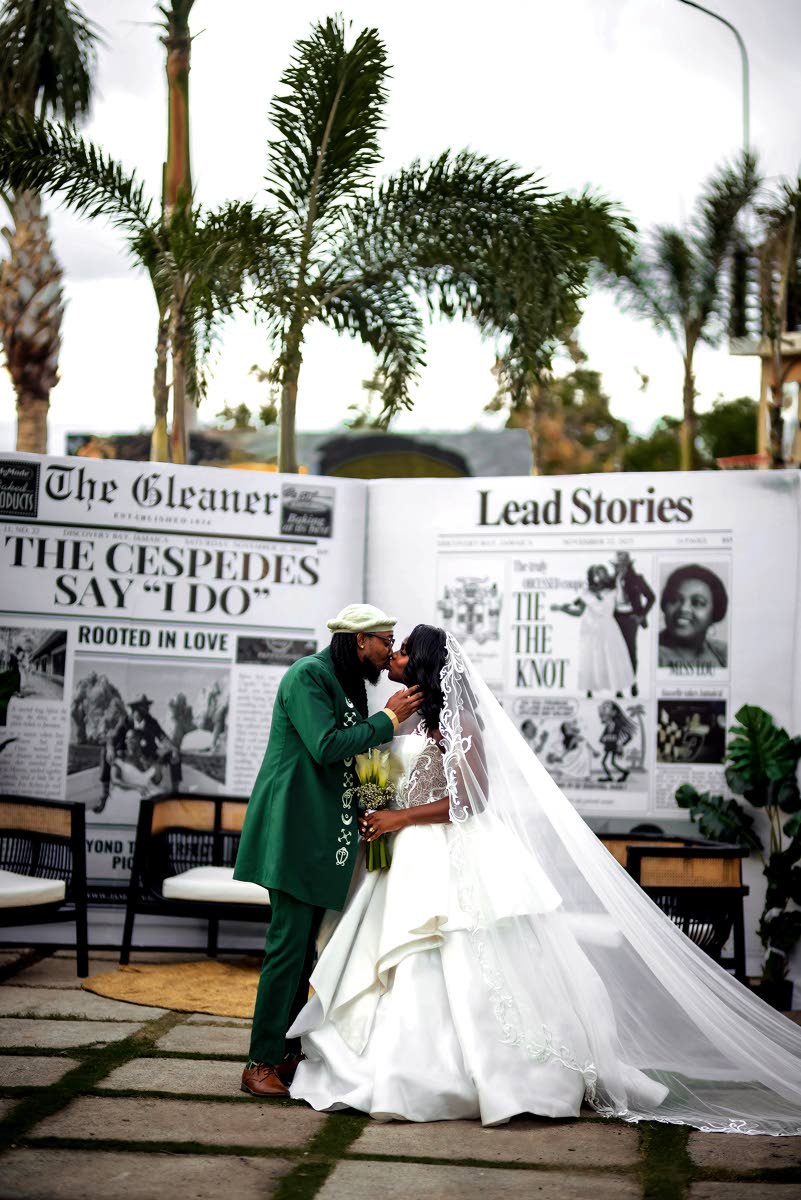The couple share an enchanting kiss in front of an extravagant newspaper announcement marking their wedding.