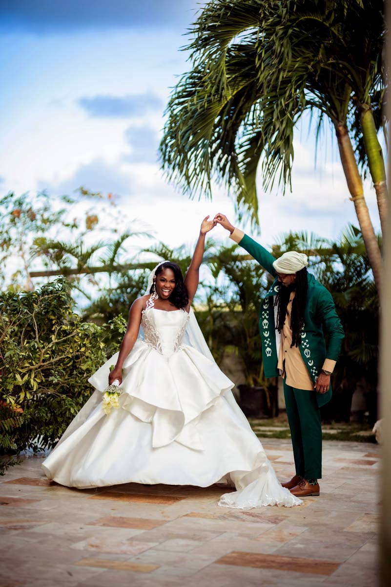 Giving his bride a twirl, Kelsey-Jo stole the show in a layered fit-and-flare dress with a vintage-inspired bodice. She designed the look herself, working with a Nigerian tailor and graphic artist to bring it to life.