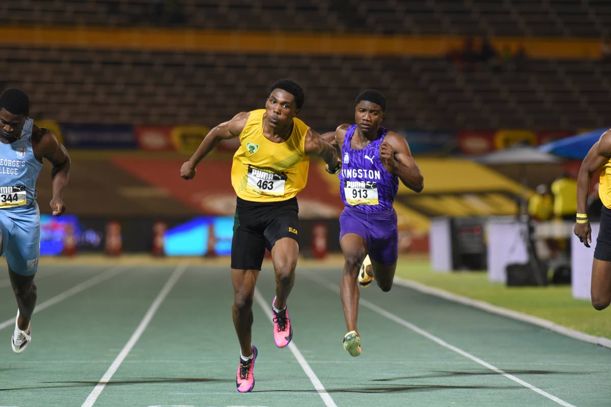 Excelsior High School’s Riquelme Reid wins the Boys’ Class 1 100 metres at the ISSA/GraceKennedy Boys and Girls’ Athletics Championships inside the National Stadium yesterday. 
