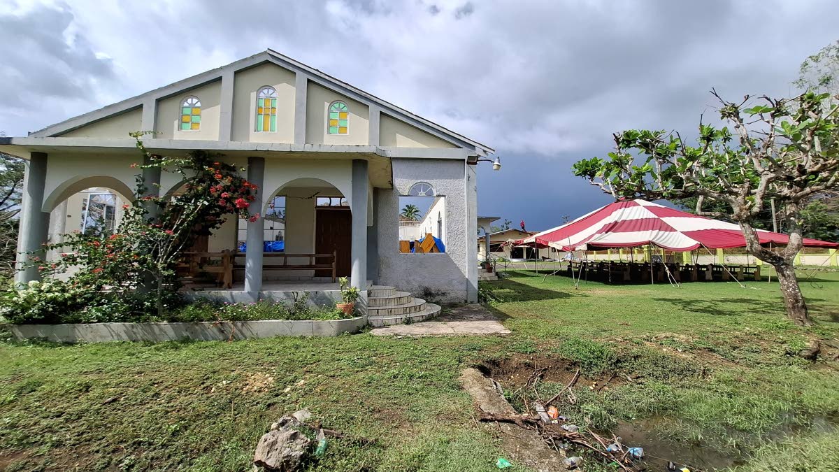 The Petersfield Holiness Wesleyan Church in Westmoreland shows extensive damage after Hurricane Melissa, leaving the congregation to worship in a tent.