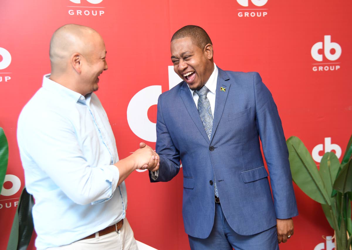 Floyd Green (right), minister of agriculture, fisheries and mining, is greeted by Matthew Lyn, chief executive officer of CB Group, at ‘The Time Is Now’ media briefing held yesterday at the Jamaica Food and Drink Kitchen in Kingston.