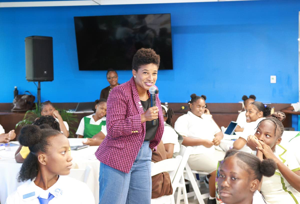 Maya Walrond, senior director, digital transformation, Flow, speaking with young women during Flow’s celebration of Girls in ICT Day on Thursday at Flow’s corporate offices in Kingston.  