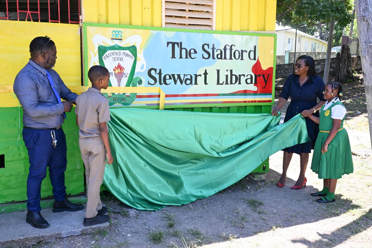 Principal of Duckenfield Primary and Infant School in St Thomas, Stafford Thomas, and education officer for Region Two in the Ministry of Education, Skills, Youth and Information, Marcia Dallas-McKenzie, unveil the sign to the institution’s newly opened 