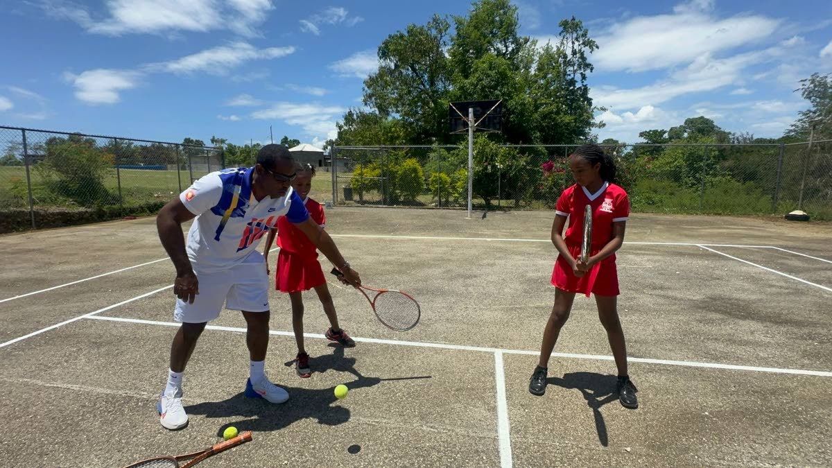Tennis player Kevin Simms shows Broughton Primary students the basics of tennis, as they eagerly take to the court during the programme’s launch.