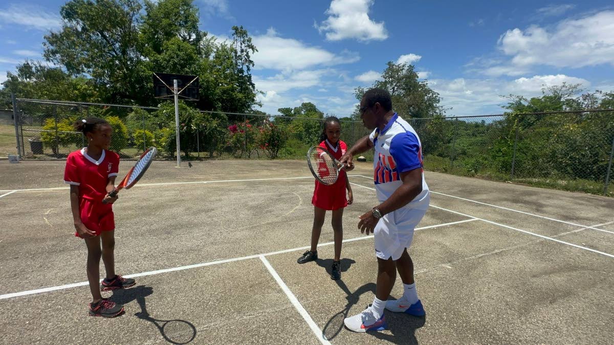 Tennis player Kevin Simms shows Broughton Primary students the basics of tennis, as they eagerly take to the court during the programme’s launch.