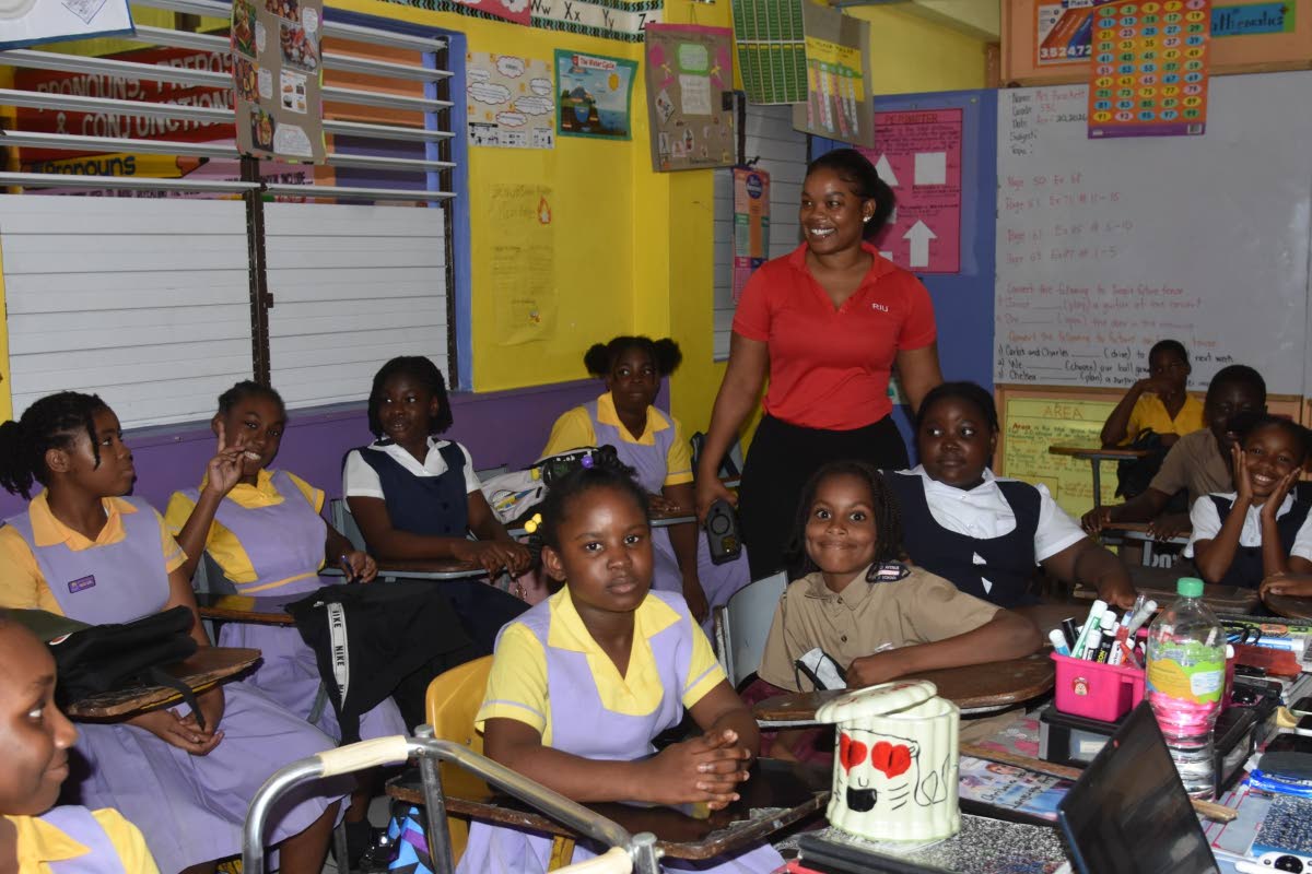 RIU Jamaica’s corporate social responsibility coordinator Crisina Campbell (standing) visits a classroom at the Wested Educational Centre in Hart Street, Montego Bay. 