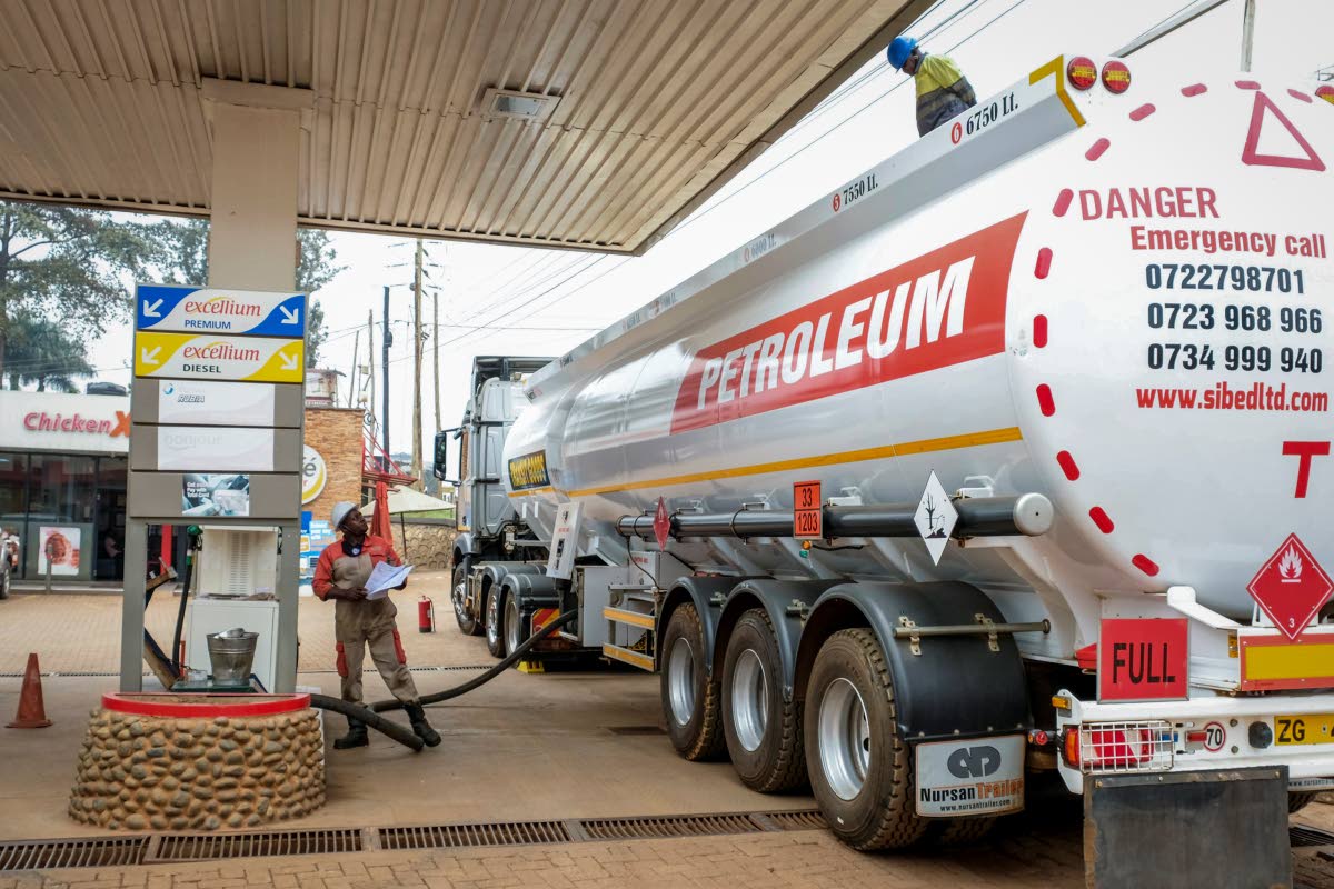 A transporter truck delivers fuel to a gas station in the Kamwokya suburb of Kampala, Uganda, Tuesday, Februrary 1, 2022. . (AP Photo)