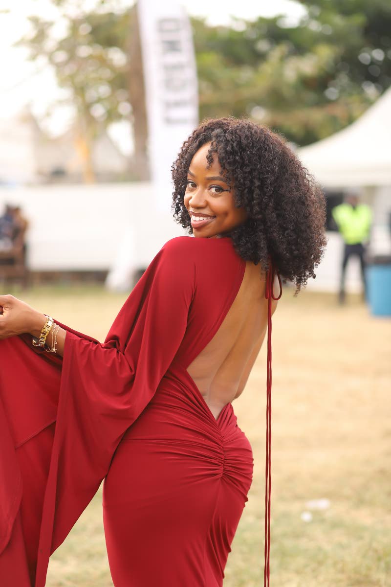 Jenn Simplice stuns in a backless dress, flashing her dimpled smile for the camera.