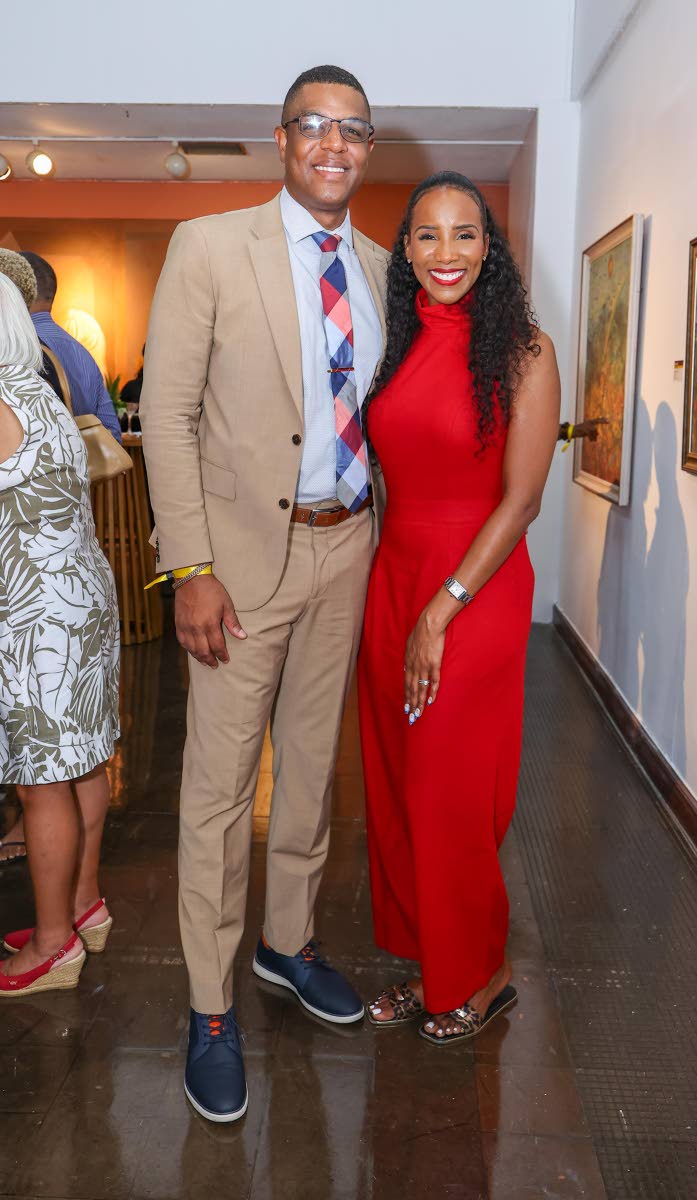 Husband-and-wife duo Major Noel Auburndale Cuthbert Lewis, a military pilot officer in the Jamaica Defence Force, and Dr Sara Lawrence Lewis, OBGYN at Charis Women’s Wellness and Maternity Care Centre, admire works by Richard Nattoo and Oliver Myrie, whi