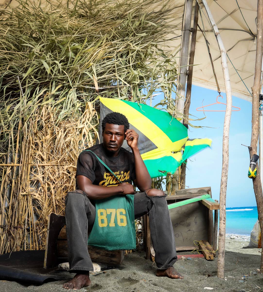 From left:
Mr World Caribbean 2024 Tarique Barrett wears the 876 Black and Gold Mesh Jersey and poses with the 876 Green Mesh Tote Bag.