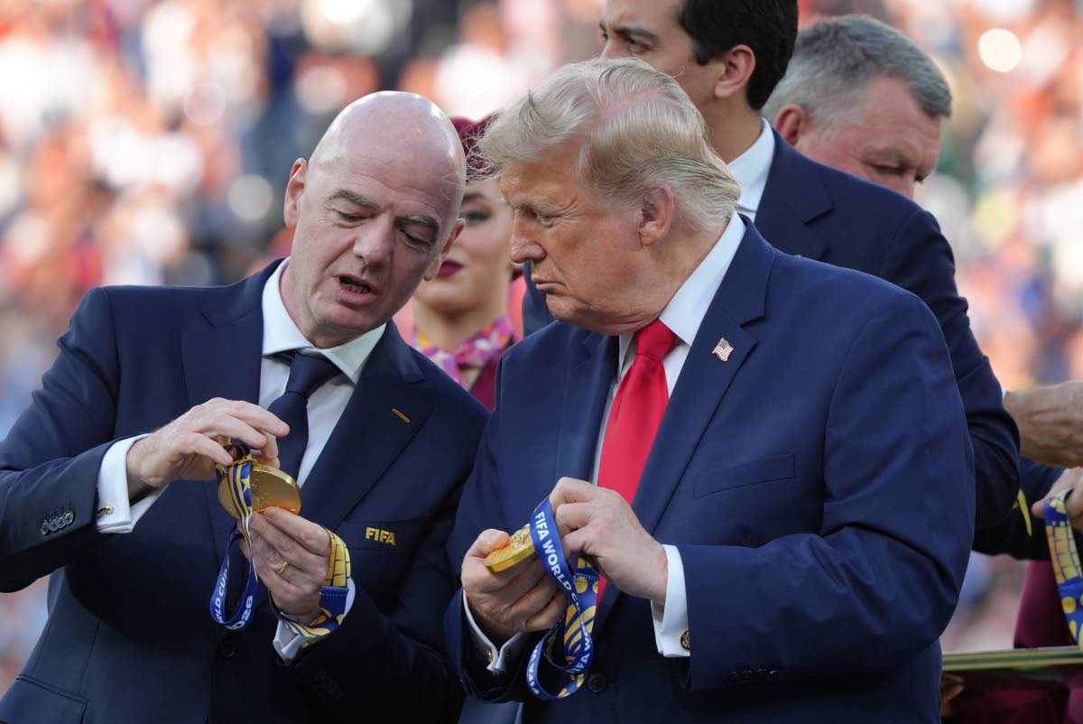 FIFA President Gianni Infantino, left, and President Donald Trump comment on the medals as they wait to congratulate the Spanish players after the World Cup final soccer match between Spain and Argentina in East Rutherford, N.J., near New York, Sunday, Jul