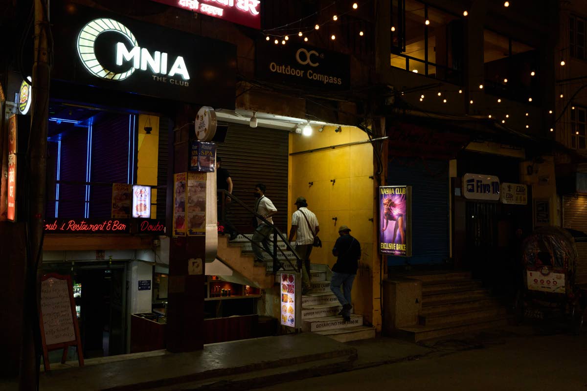 Men enter a club in Kathmandu, Nepal.