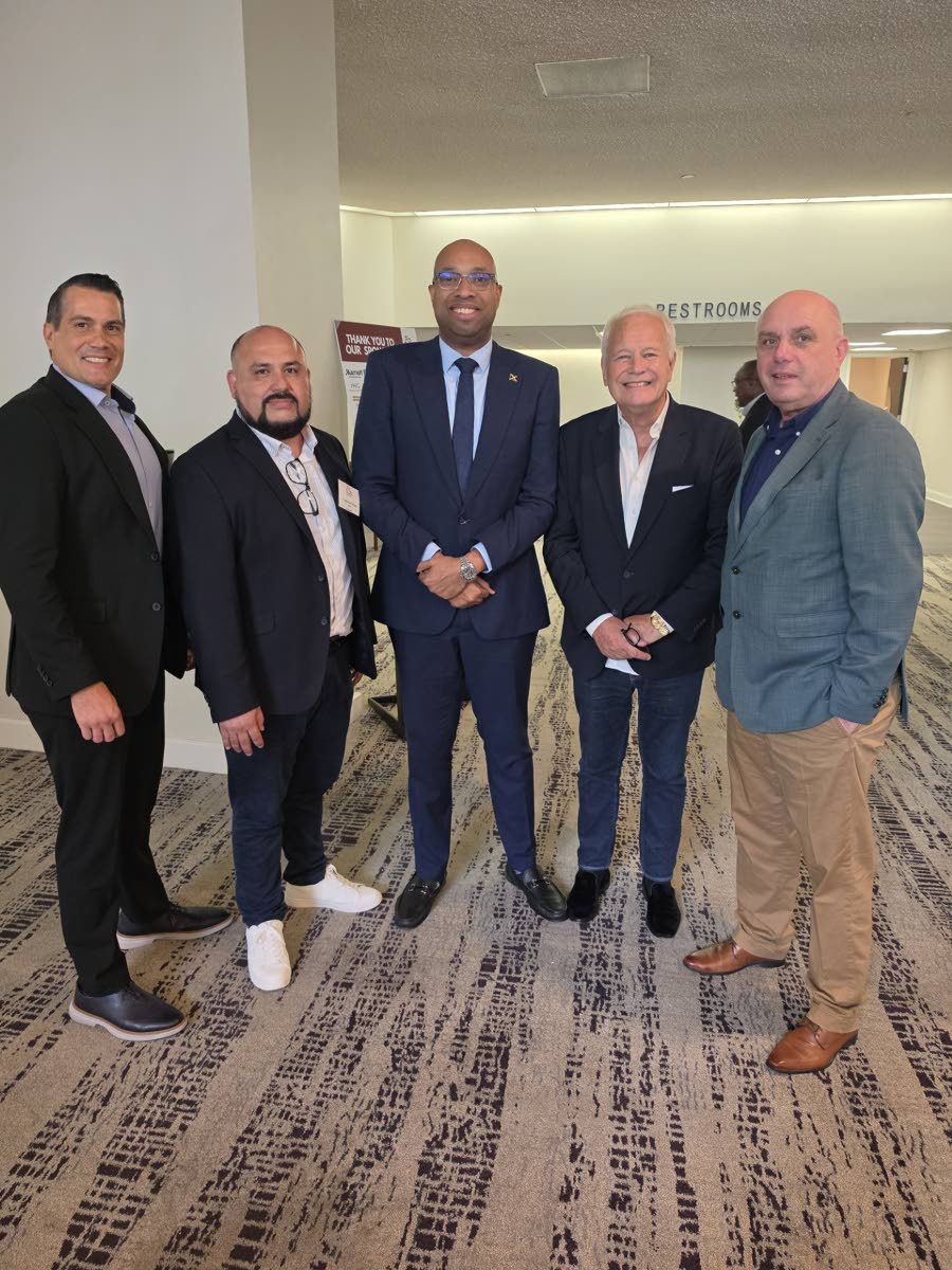 Delano Seiveright (centre), Jamaica’s minister of state in the Ministry of Industry, Investment and Commerce, is joined following his keynote address at the Marriott International Luncheon during the 30th Annual International African American Hotel Owner