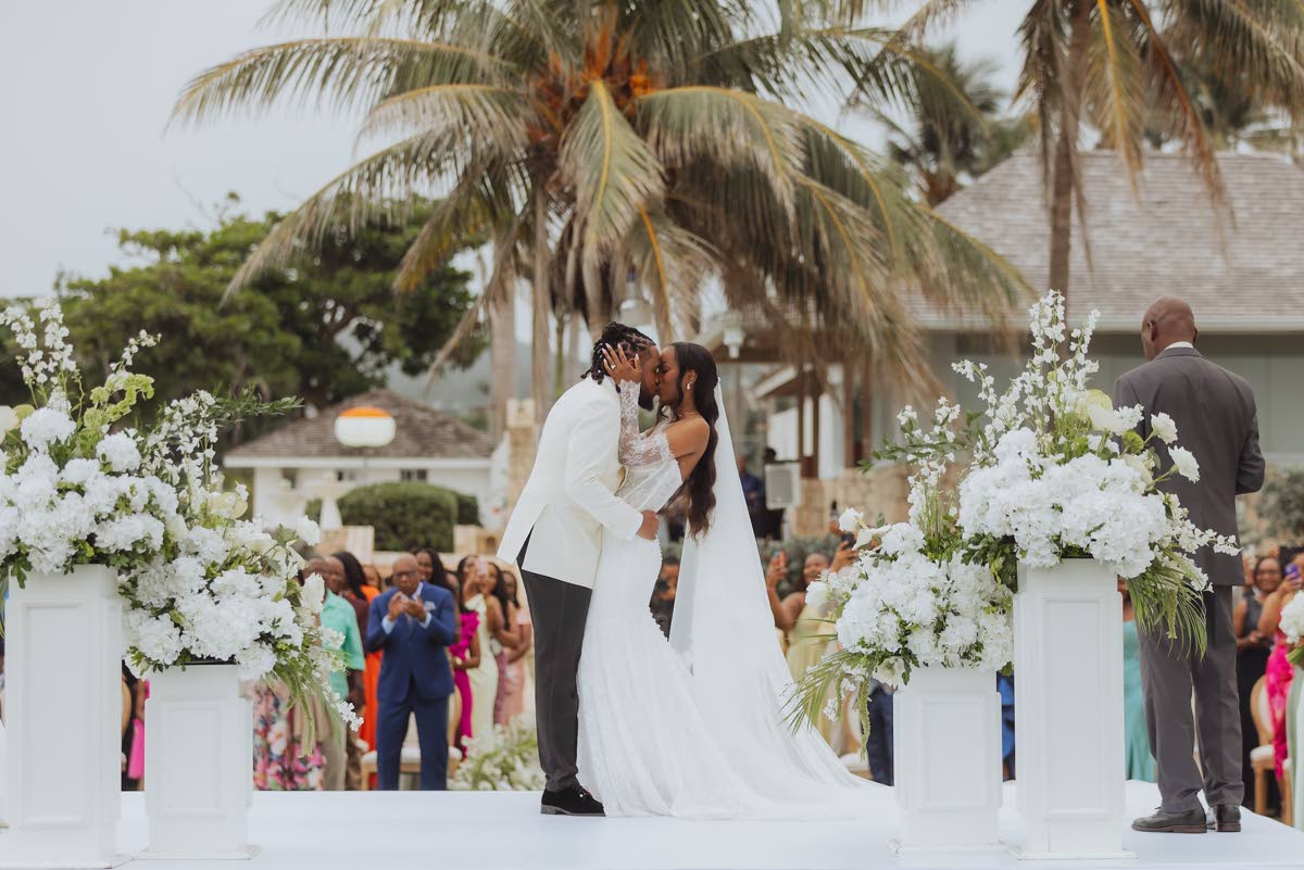 Noel and Krisann seal their nuptials with a kiss at the altar.