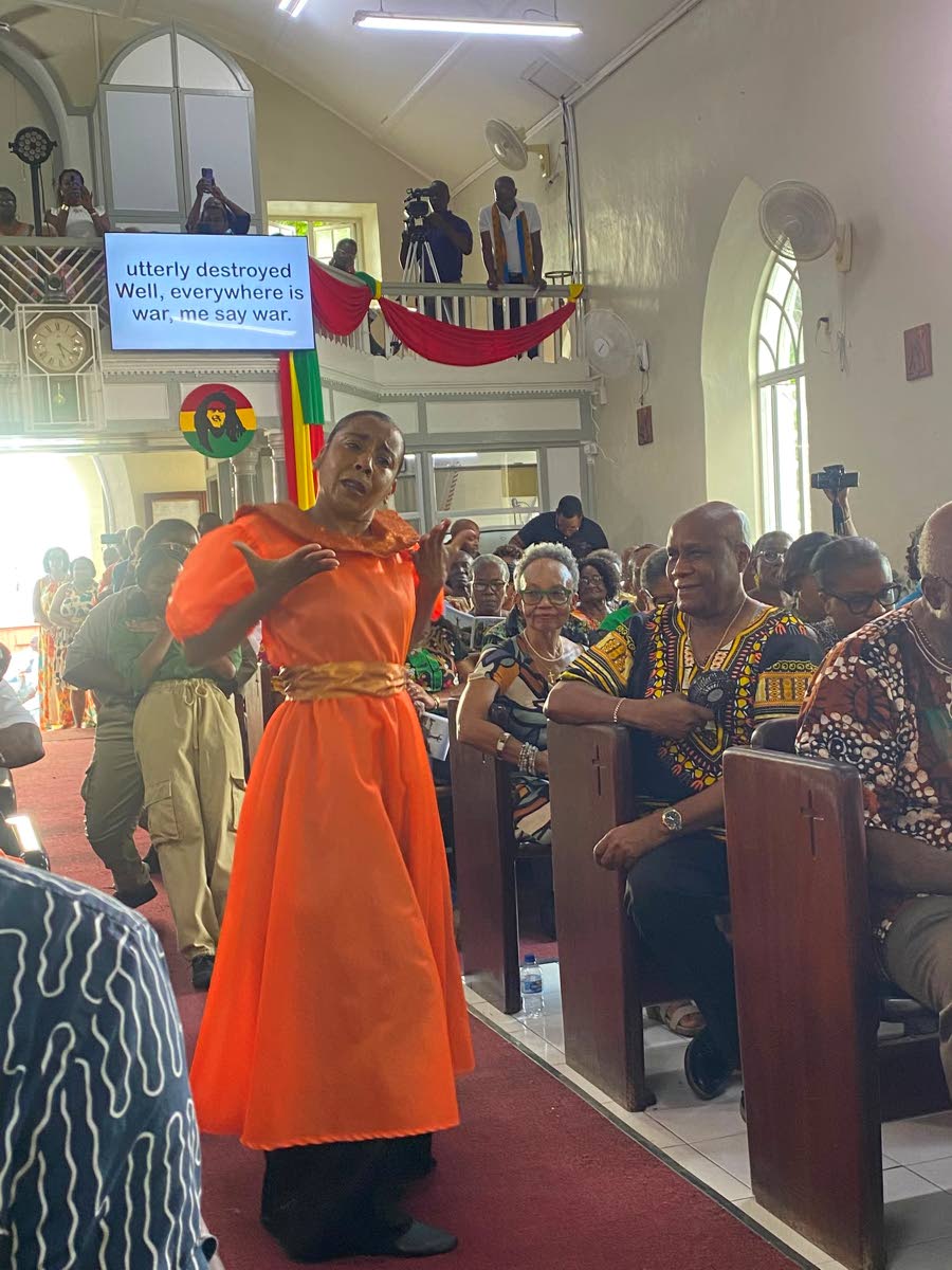 Kim Wiggins dances to one of Bob Marley’s songs during the Marley Emancipation Mass.
