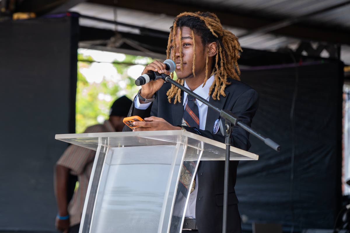 Marcus Cole, the youngest son of Stranger Cole, reads the first lesson during his father’s thanksgiving service on Wednesday at the Ranny Williams Entertainment Centre on Hope Road in St Andrew.