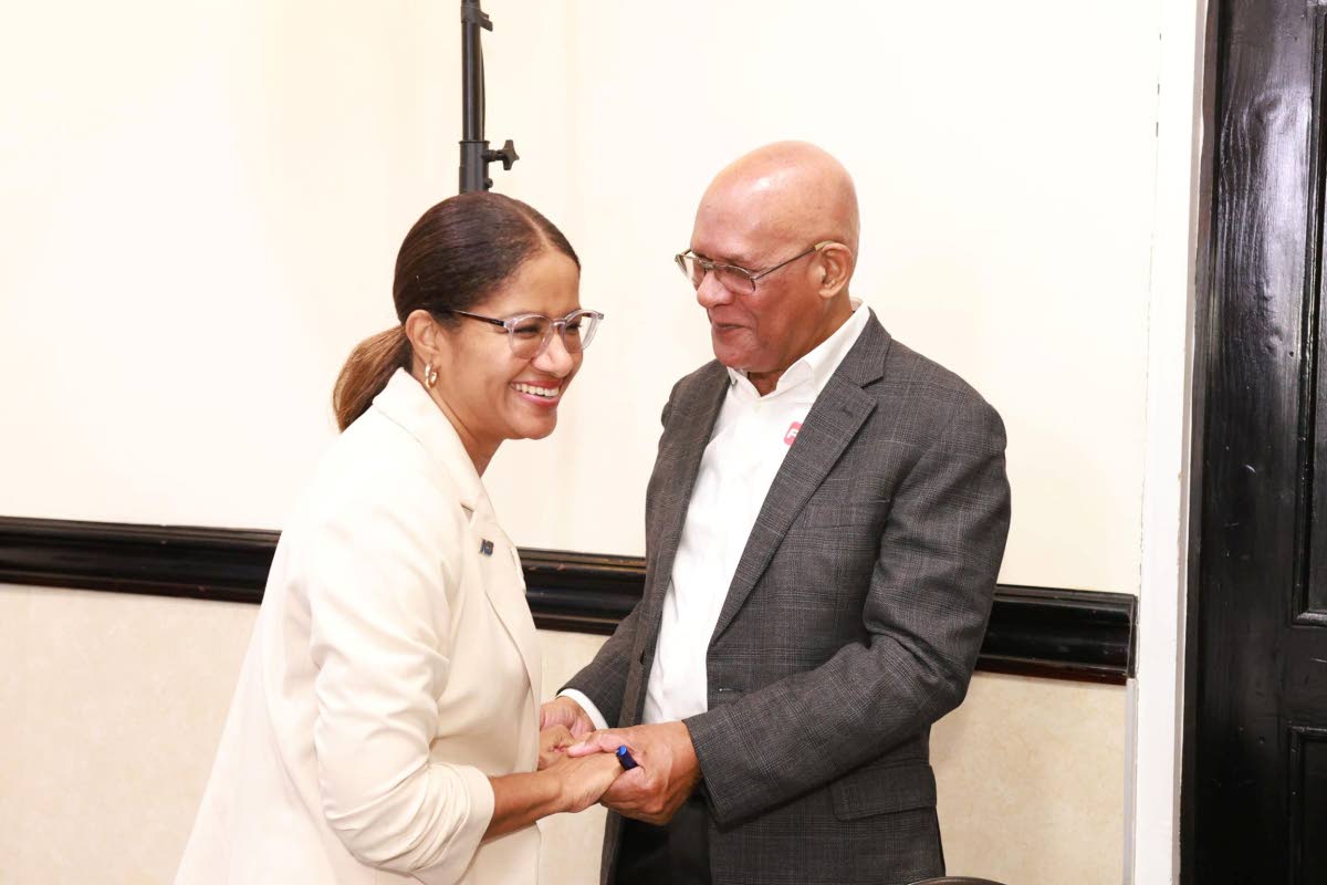 Sheree Martin (left), interim chief executive officer, National Commercial Bank Jamaica Limited (NCBJ), with Errol McGaw, treasurer, FESCO.
