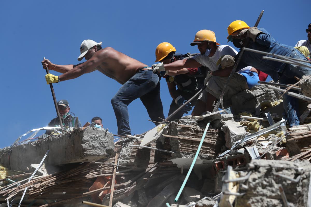 Residents and rescue workers search through the rubble after an earthquake struck Cali, Colombia, last Monday.