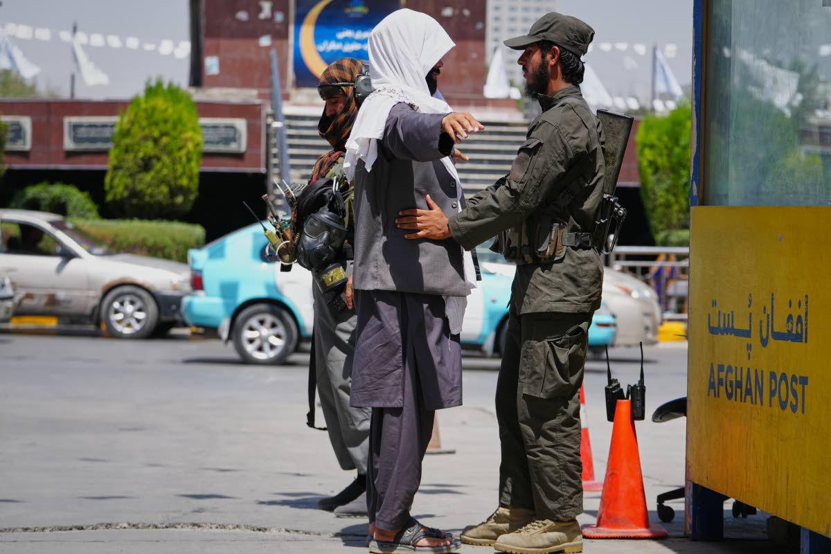 A Taliban security officer searches a man at a checkpoint ahead of celebrations marking the fifth anniversary of the US withdrawal from Afghanistan and the start of Taliban rule, in Kabul, Afghanistan, last Thursday.