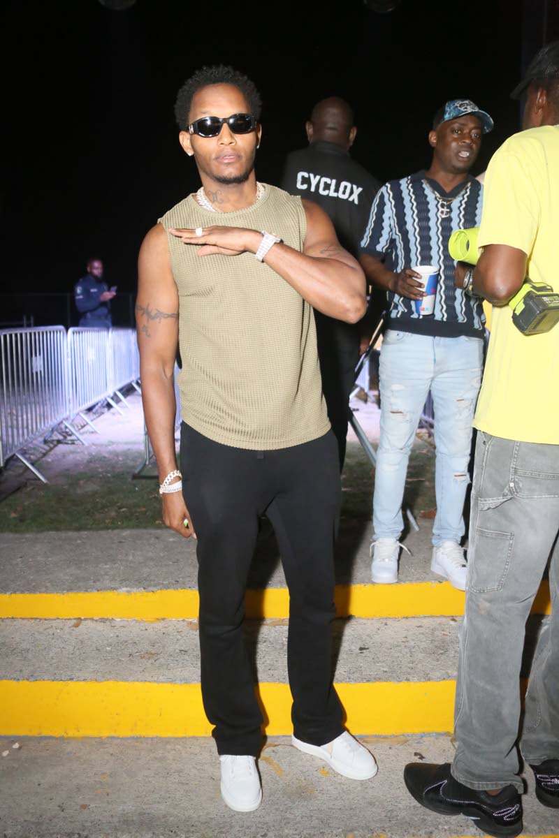 Entertainer Leftside is snapped at FRi~NALLY in a khaki muscle tee, black trousers and white low-tops.