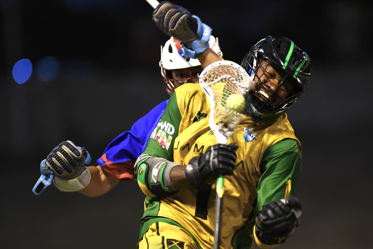 Ian Allen/Photographer 
Matthew Marrett from Jamaica, powers past Ryan Stowell from Puerto Rico in the Pan Am Men’s Lacrosse Championship at the Stadium East field on Friday.