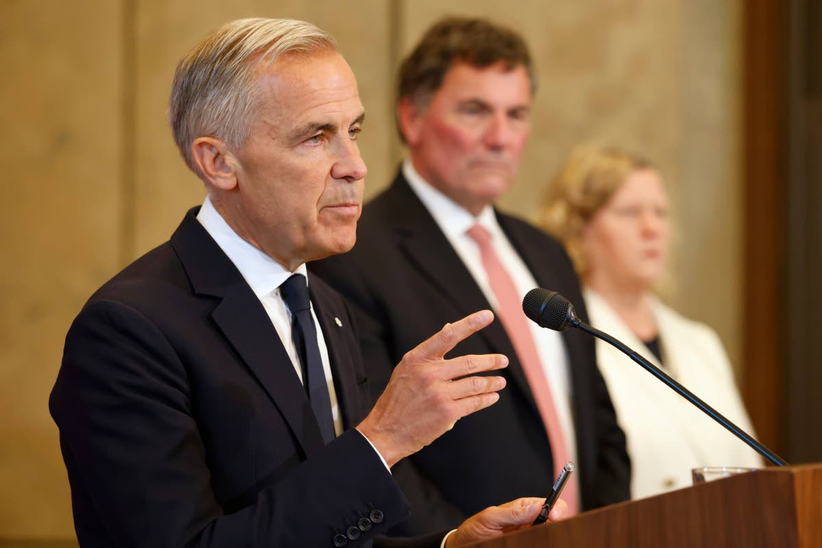 Canada’s Trade Minister Dominic LeBlanc and chief trade negotiator Janice Charette listen as Prime Minister Mark Carney speaks about Canada’s response to new US tariffs during a news conference on Parliament Hill in Ottawa on Saturday, August 22.  AP