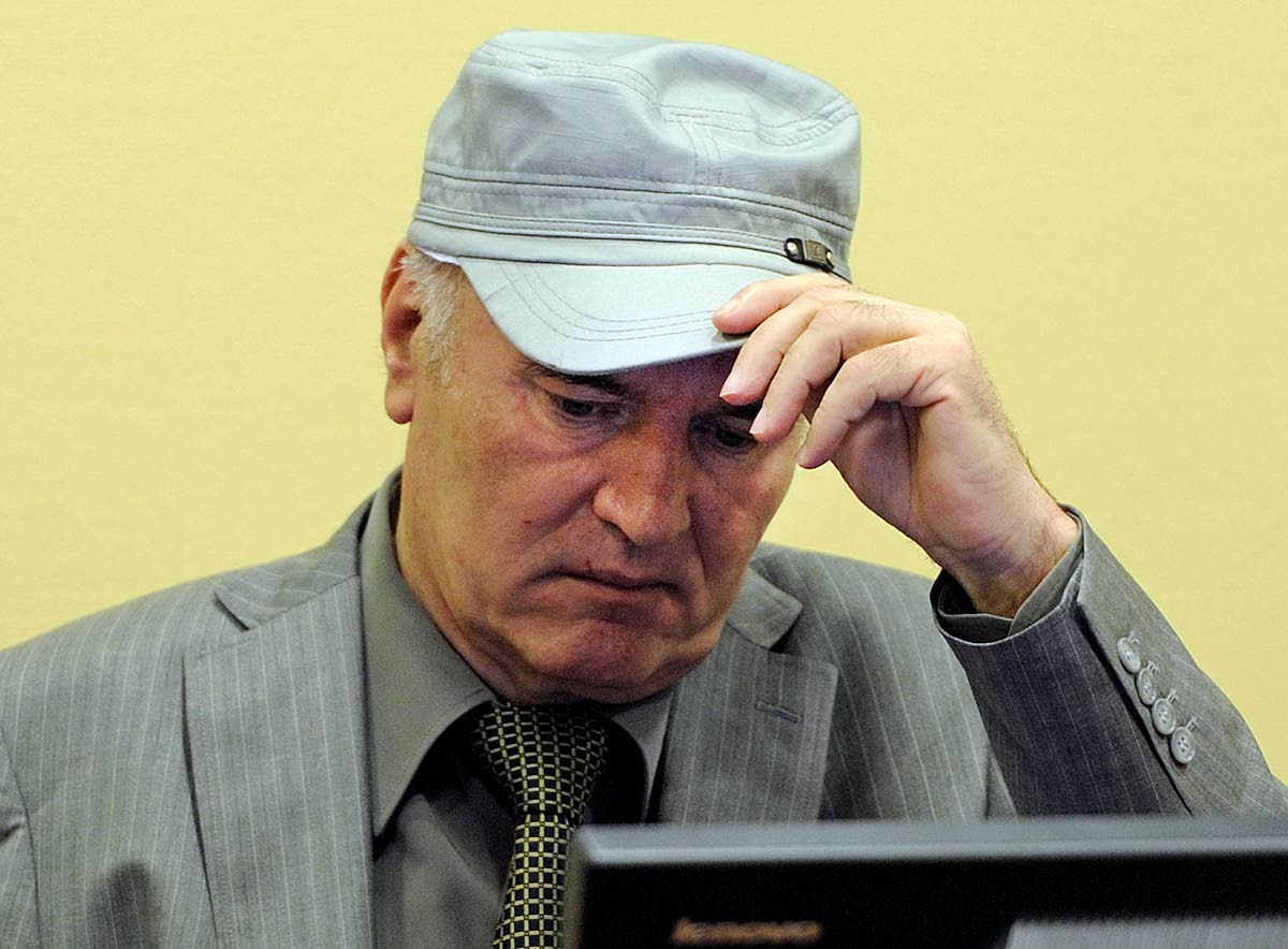 Ratko Mladic removes his hat in the court room during his initial appearance at the UN's Yugoslav war crimes tribunal in The Hague, Netherlands, June 3, 2011. 