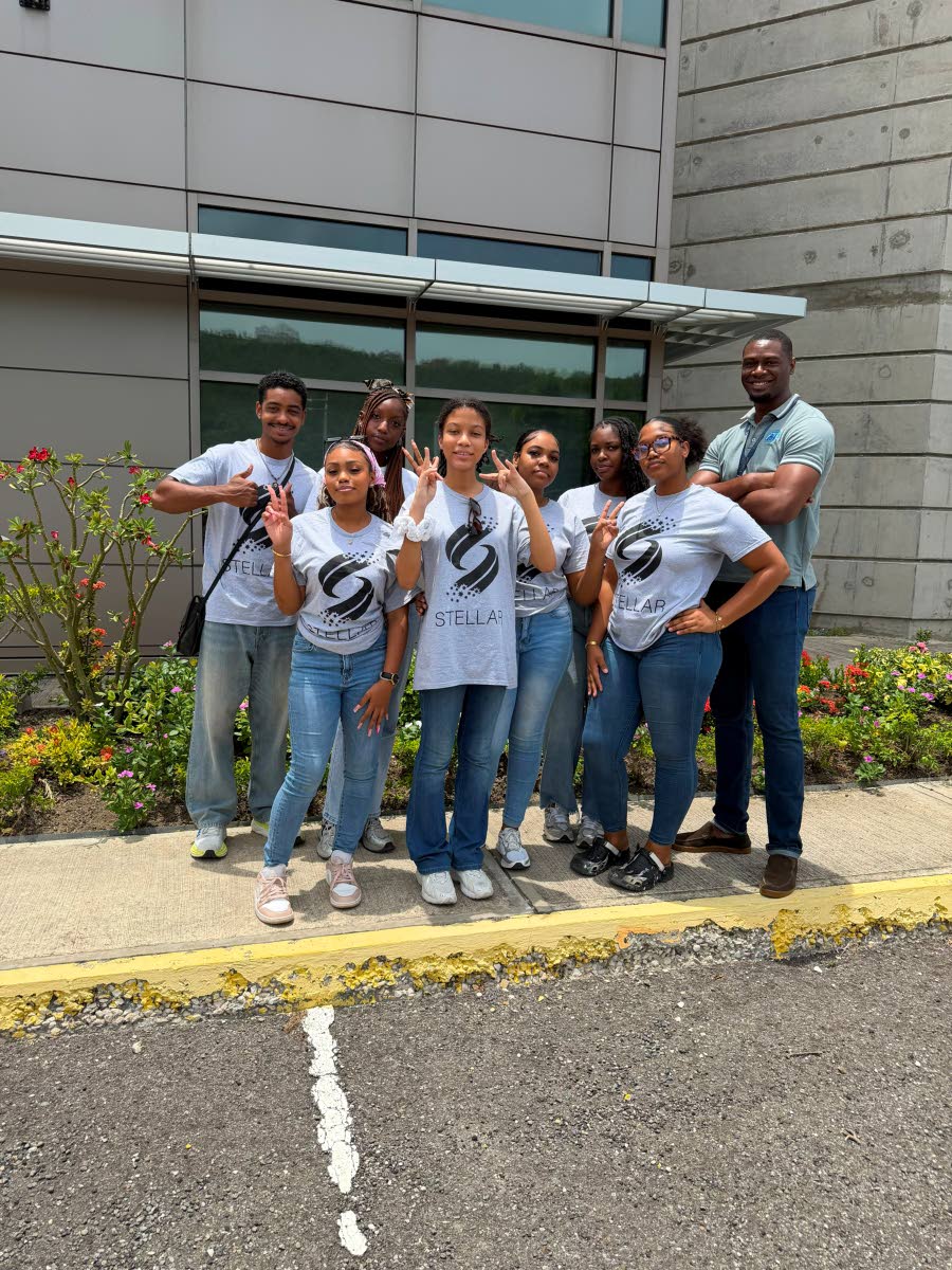 Stellar Foundation founder Romulus Deenah (back row, left) and Mount Alvernia High School students participating in the foundation’s 2026 summer programme share lens time with Petro Pinnock, their mentor and guide during a tour of the air traffic control