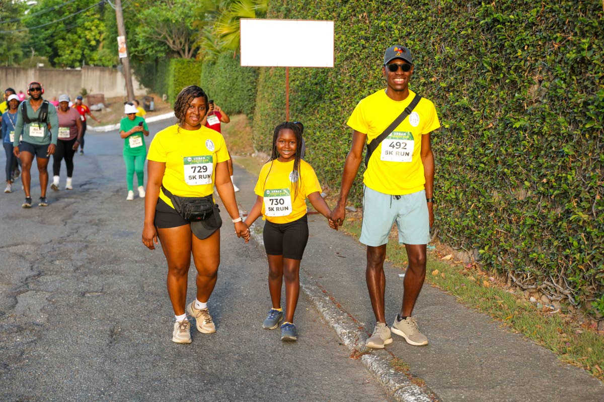 From left: Trushauna Cameron, Khalisi Hyatt and Kareem Hyatt of the Bank of Jamaica team bring a burst of sunshine to the track.
