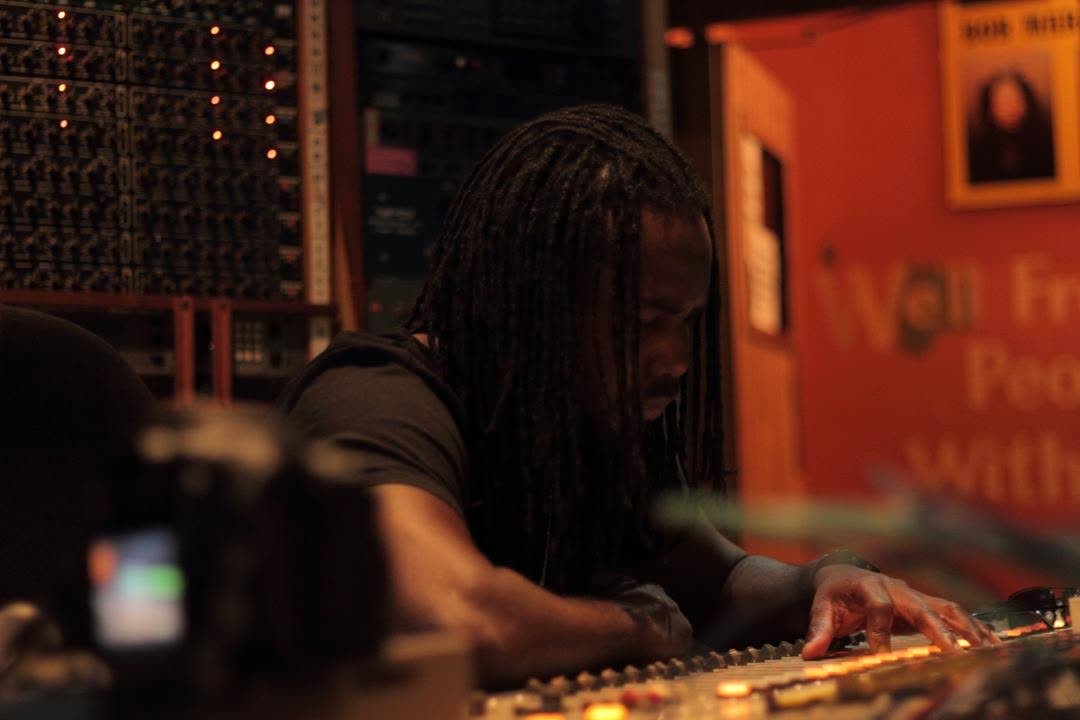 The prolific multi-hyphenate in music producer mode in between a studio recording session.