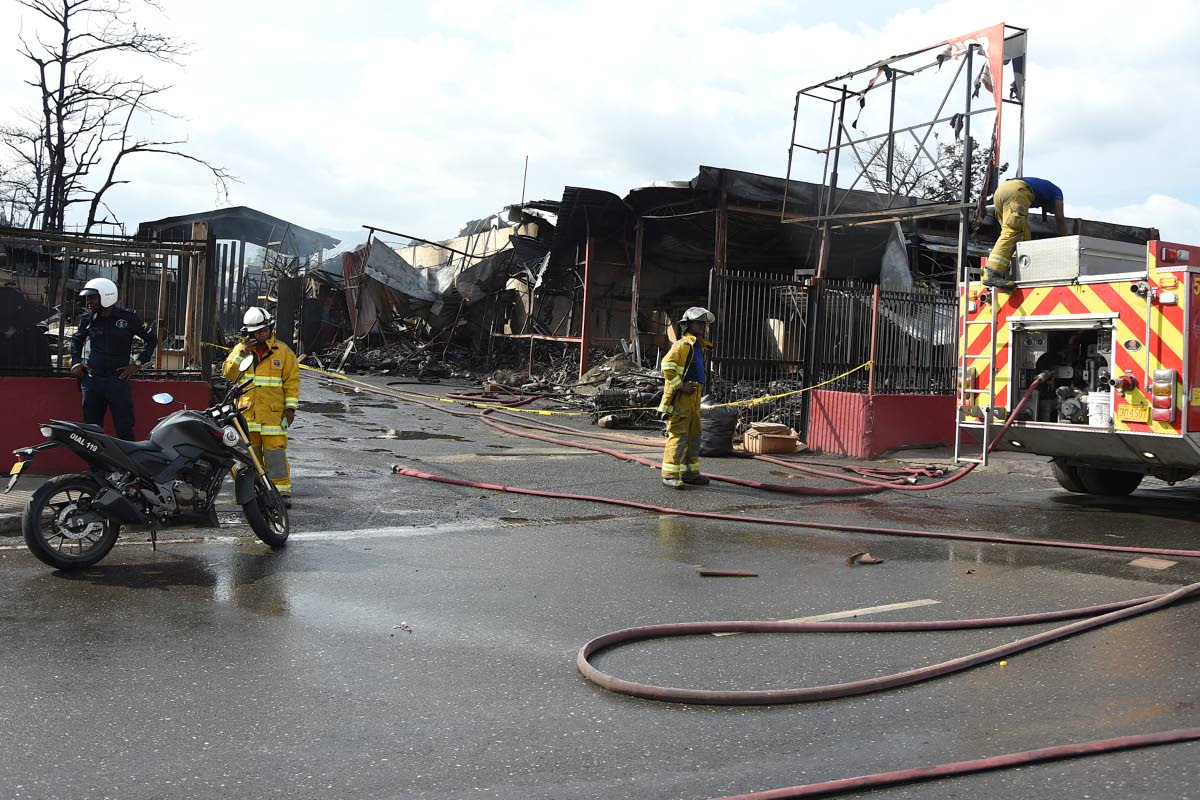 Firemen perform cooling down operations at the Superior Parts facility along Hagley Park Road on Friday, after a massive fire burnt through the building Thursday afternoon.