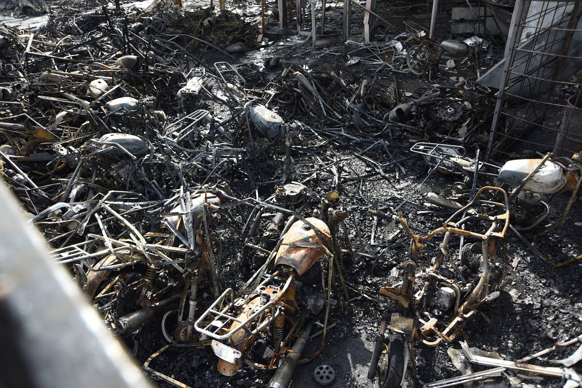 Burnt out motorcycles at the bike section of the Superior Parts building along Hagley Park Road in St Andrew on Friday. 