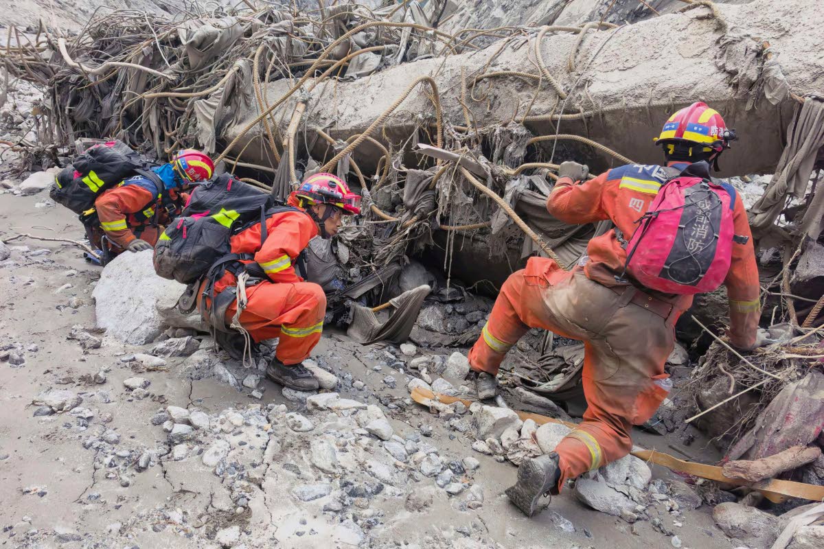 In this photo released by Xinhua News Agency, rescuers carry out search and rescue operations at the mudslide-hit area in Gyirong County, southwest China’s Tibet Autonomous Region.