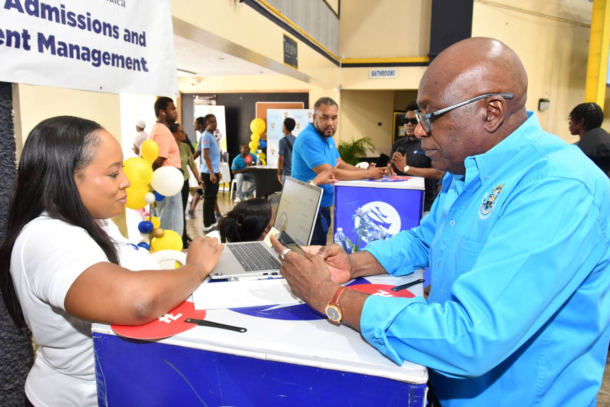 Russchanie Douglas (left), senior relationship manager at Mayberry Investments Limited, interacts with Paulton Gordon, community development director at the University of Technology, Jamaica. The two connected at the UTech ‘Week of Welcome’ Orientation