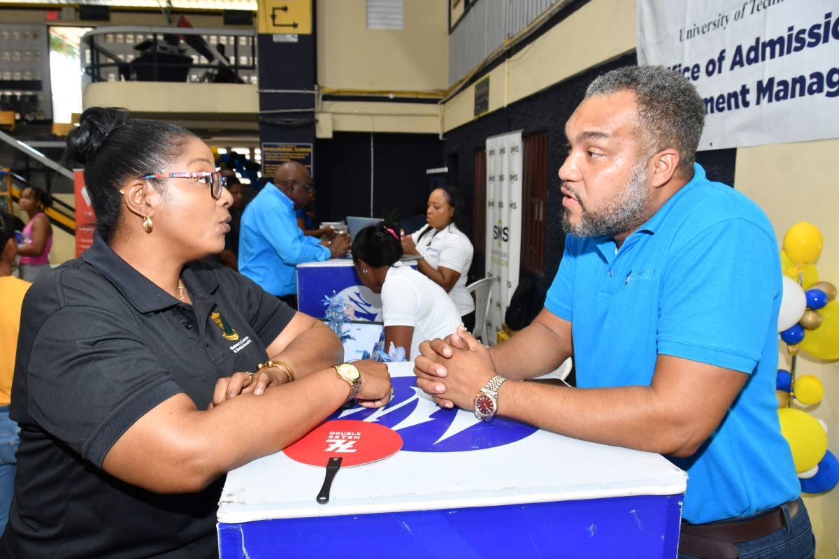 Discussing financial literacy and wealth-building, Brian Munroe (right), Senior Relationship Manager at Mayberry Investments Limited, interacts with Tamara Henry. The two were pictured at the University of Technology Jamaica ‘Week of Welcome’ Orientati