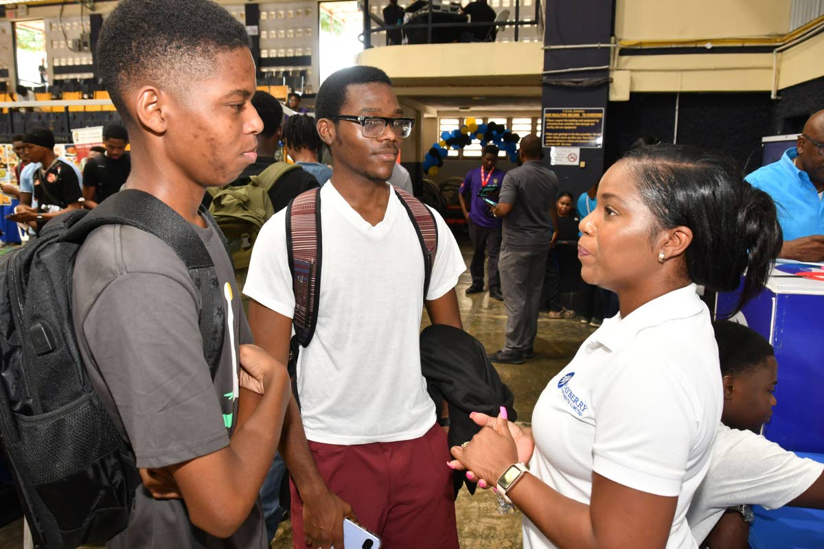 Engaging the next generation of investors, Kerry-Ann South (right), senior relationship manager at Mayberry Investments Limited, speaks with incoming students Jordane Baker and Martinez Webb. 