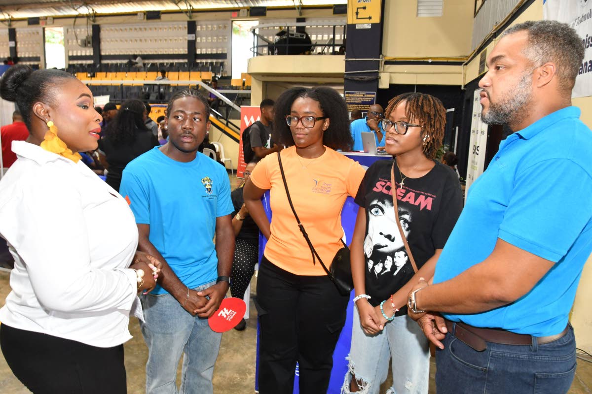 Students Gregory Smith (second left), Raecine Davis(centre) and Allyanna Morris (second right) listen attentively alongside Terry-Ann Rhule, student welfare officer at the University of Technology Jamaica, as Brian Munroe, senior relationship manager at Ma