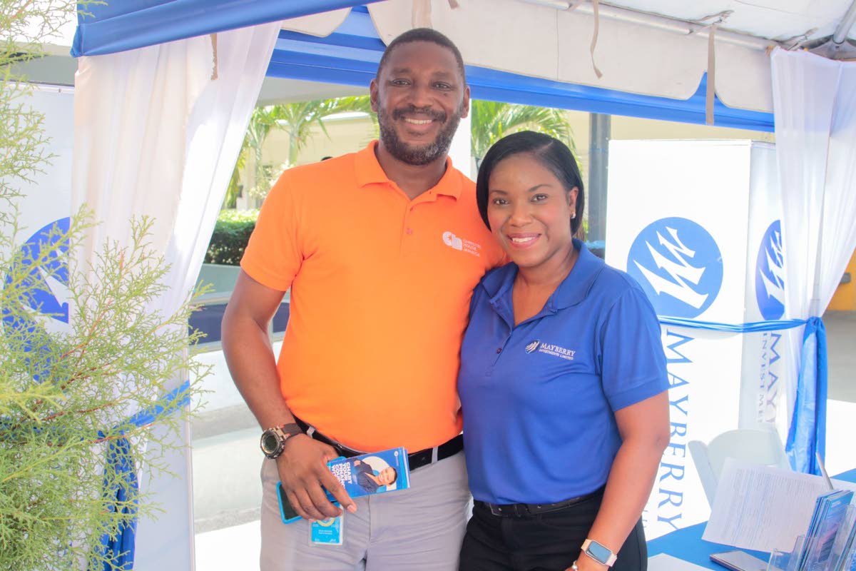 Paul Wilson (left), dean of discipline at Christel House Jamaica, and Kerry-Ann South (right), senior relationship manager at Mayberry Investments Limited, pause for a photo at the Christel House Jamaica Kick Off Week Information Fair. 