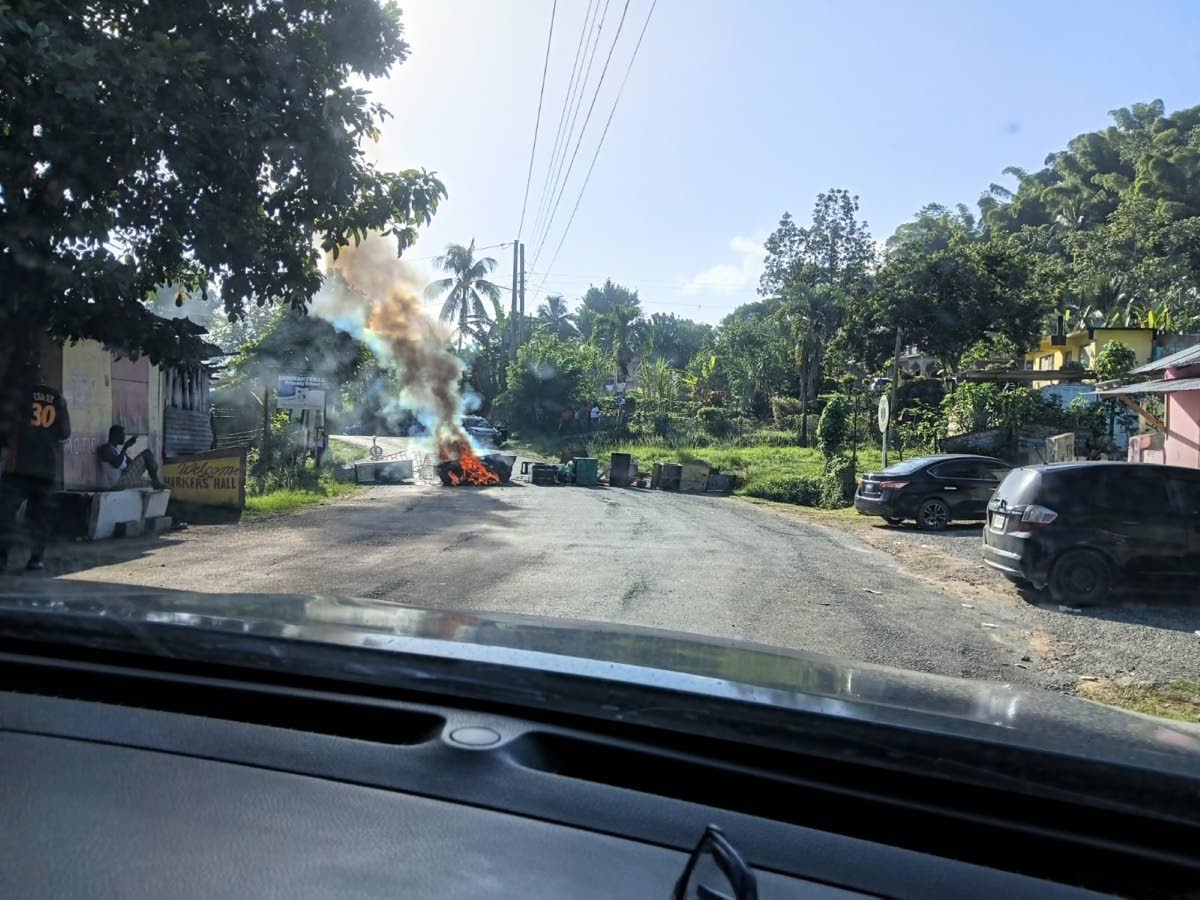 A fiery roadblock in Harkers Hall, St Catherine, mounted by residents to protest the death of Lenroy York on Sunday night. The roadblock disrupted early Monday morning traffic along the thoroughfare linking communities including Bog Walk, Glengoffe and Abo