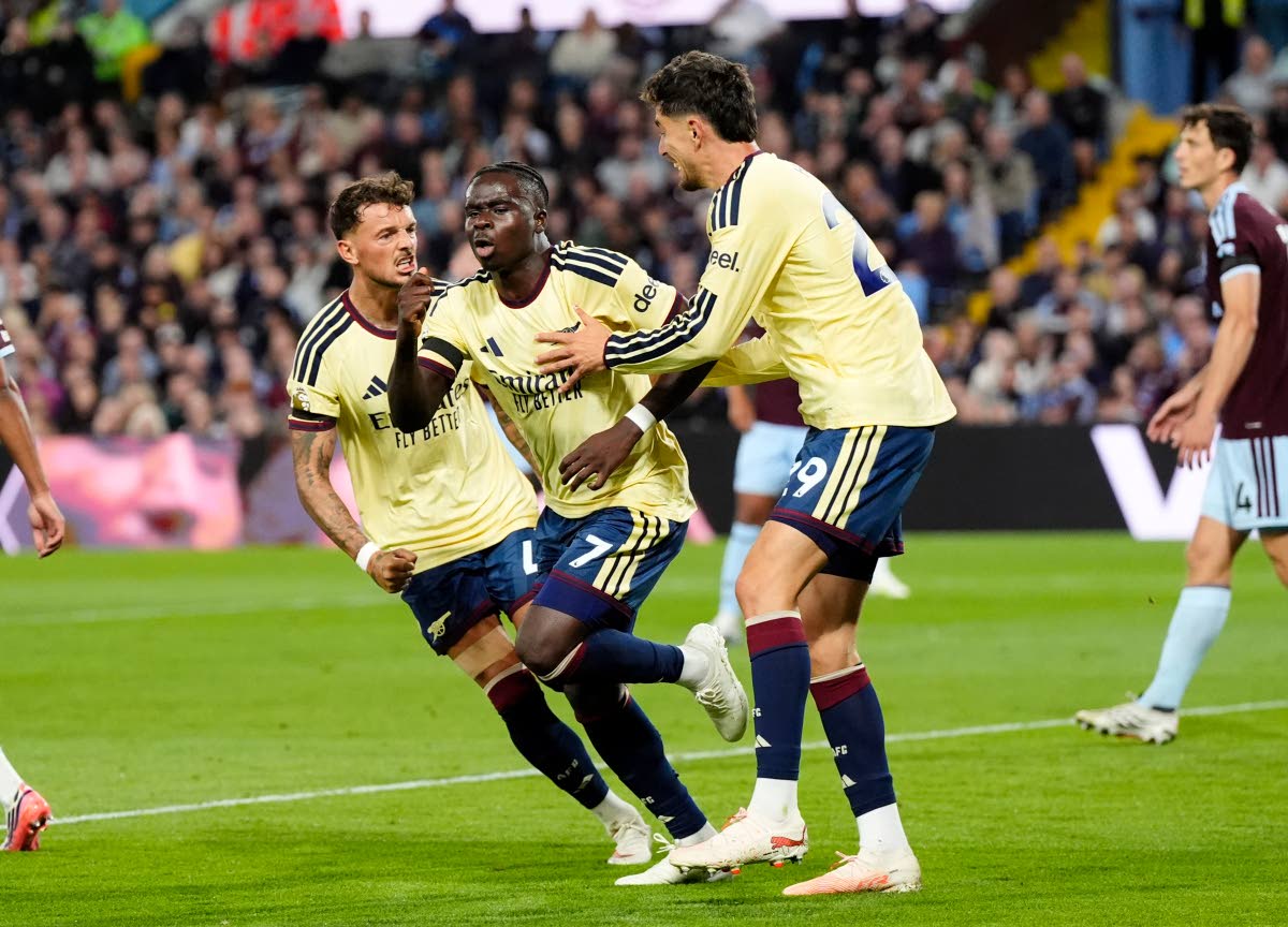 Arsenal's Bukayo Saka (7) celebrates after scoring his side's opening goal during the English Premier League soccer match between Aston Villa and Arsenal in Birmingham, England, Monday, Aug. 31, 2026. (Nick Potts/PA via AP)