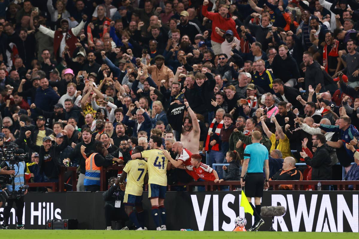 Arsenal's Bukayo Saka (7) celebrates with team mate Arsenal's Declan Rice after scoring his side's opening goal during the English Premier League soccer match between Aston Villa and Arsenal in Birmingham, England, Monday, Aug. 31, 2026. (AP Photo/Morgan H