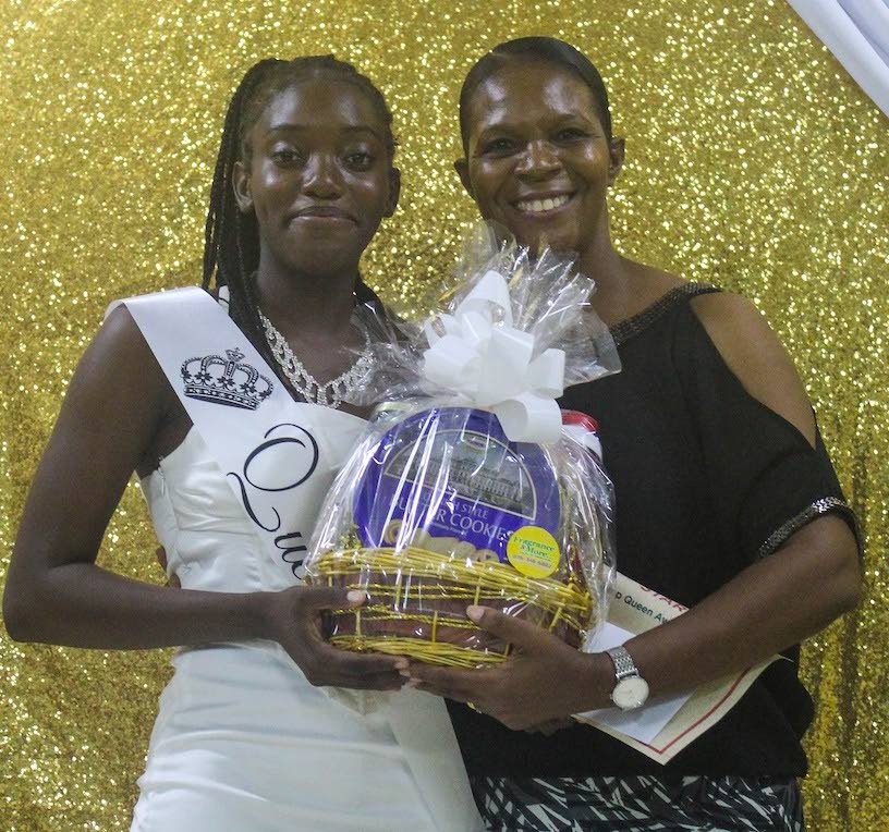 Regina Taylor (left), the Project STAR Youth Summer Leadership Camp Queen, receives a gift from Sharise Staines-Appleby, head of programmes at Project STAR,  during the camp’s closing ceremony at Tapioca Village Retreat in St Mary.