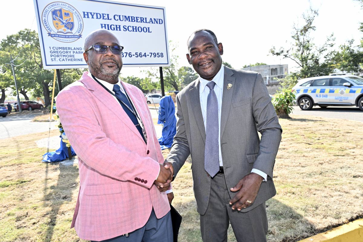 Carlon Pitt (left), former principal of Cumberland High and the headmstaer at the new Hydel Cumberland High School, greets Dr Walton Small, retired principal of Hydel High. 