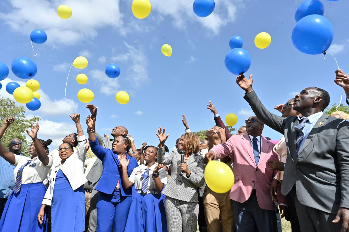 Students and officials release balloons on Monday during a ceremony to mark the merger of Hydel High and Cumberland High to form the new Hydel Cumberland High School in Portmore, St Catherine.