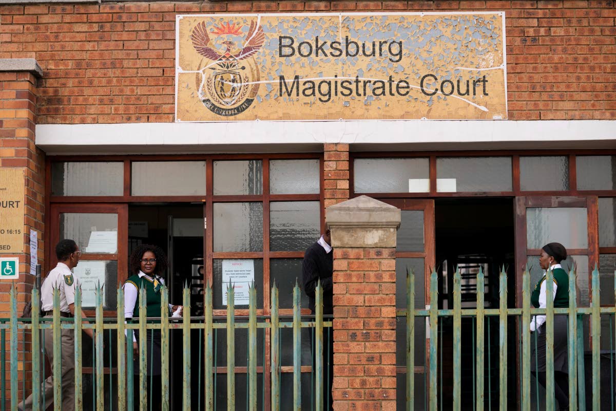 Court workers are seen at the entrance of the Boksburg Magistrate Court, east of Johannesburg, South Africa last Monday, where suspects appeared in connection with one of a series of killings of women near Johannesburg. 