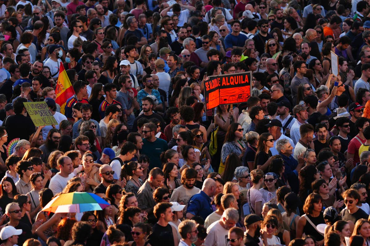 People gather during a protest following the eviction last Wednesday of 87-year-old Maricarmen to demand stronger laws to protect renters at Puerta del Sol in Madrid, Spain on Saturday.