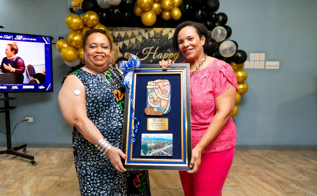 MILESTONE MOMENT: Shipping Association of Jamaica President Corah Ann Robertson-Sylvester presents Denise Lyn Fatt (left) with a commemorative work of art marking her 50 years of service to the maritime industry.