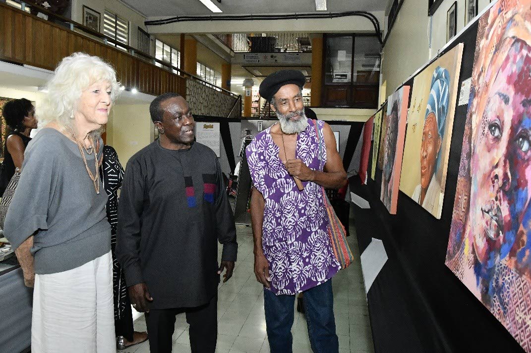 left: Professor Hopeton Dunn (centre) speaks with artist, Samere Tansley and poet and musician M’Bala- two visitors to the KGOTLA exhibition launch. 